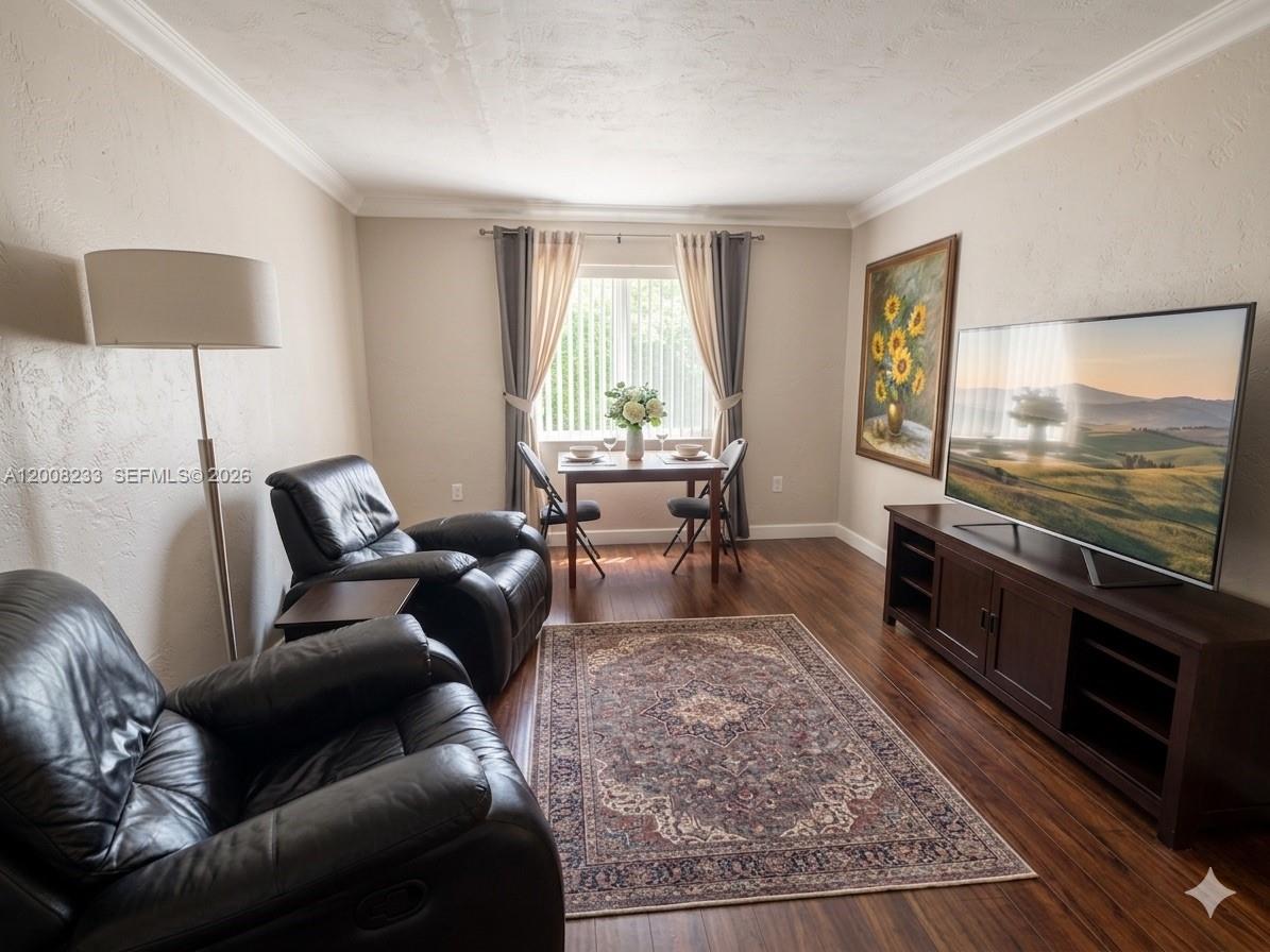 A living room with dark leather recliners, a dining set, and a television on a console — 8605 SW 68th Ct # 7, Pinecrest FL 33156, PINECREST, FL