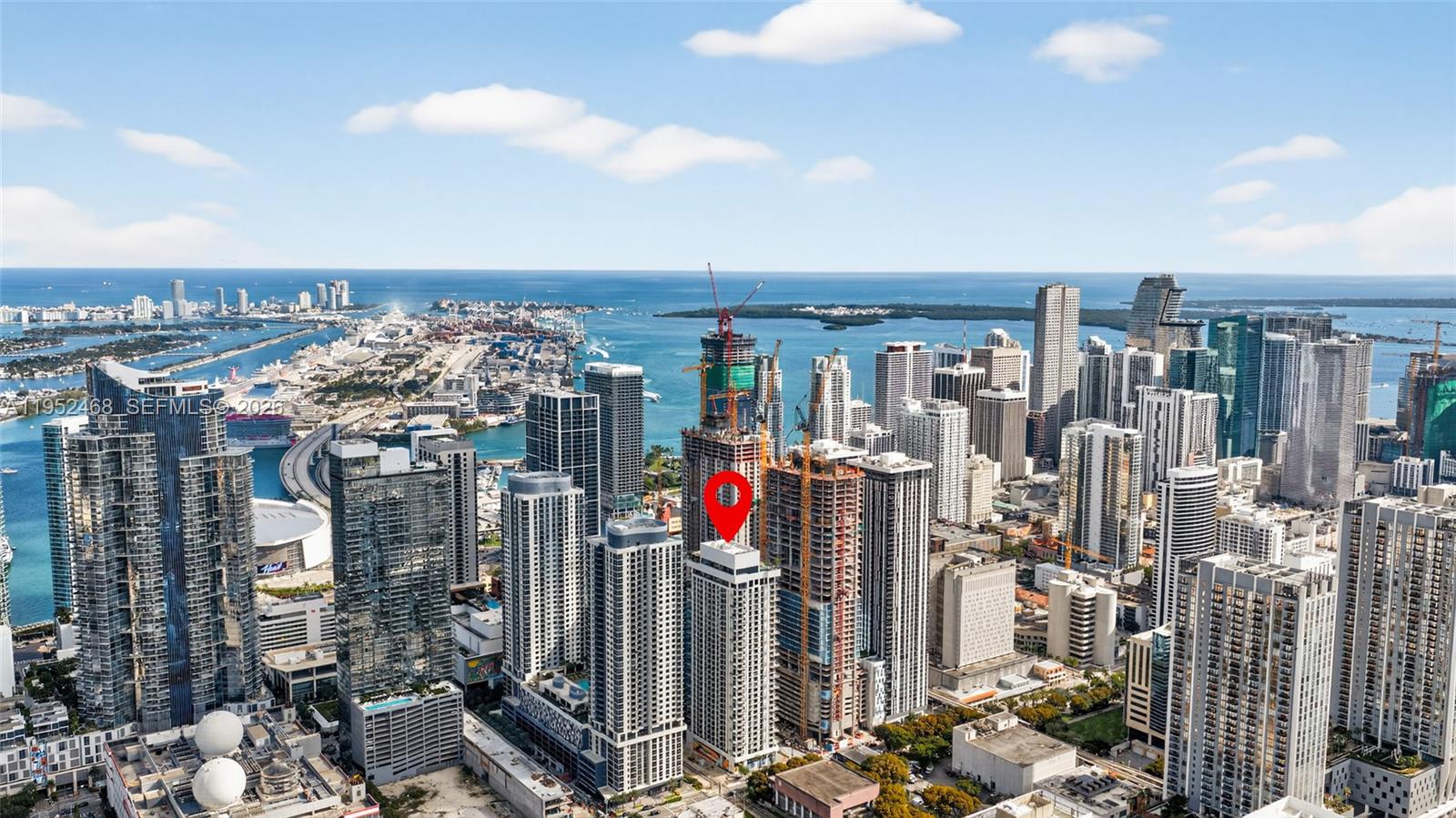 This is an aerial view of the Miami skyline featuring a red location marker — 11 NE 6 ST # 3210, Miami FL 33132, MIAMI, FL