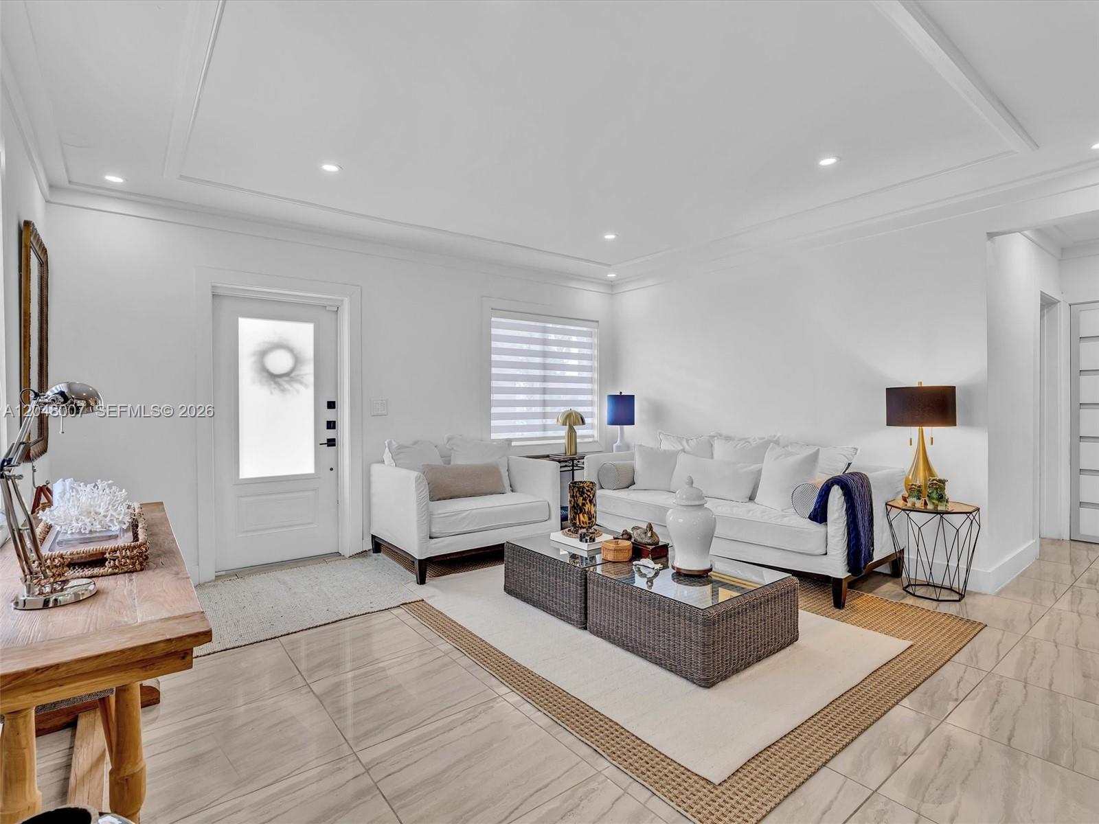 A bright living room features white furniture, a glass-topped coffee table, and tiled flooring — 310 SW 65th Ave, Miami FL 33144, MIAMI, FL