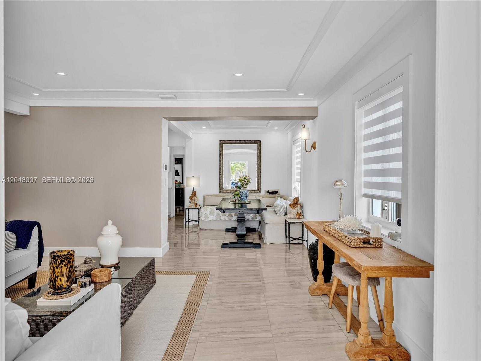 A bright living area features tile floors, a wooden console table, and a dining nook — 310 SW 65th Ave, Miami FL 33144, MIAMI, FL
