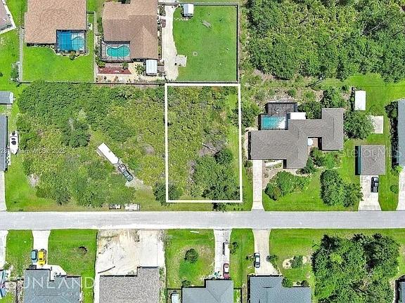 This aerial view shows a vacant, rectangular residential lot situated between two existing houses — 7296 SKYCREST STREET, ENGLEWOOD, FL