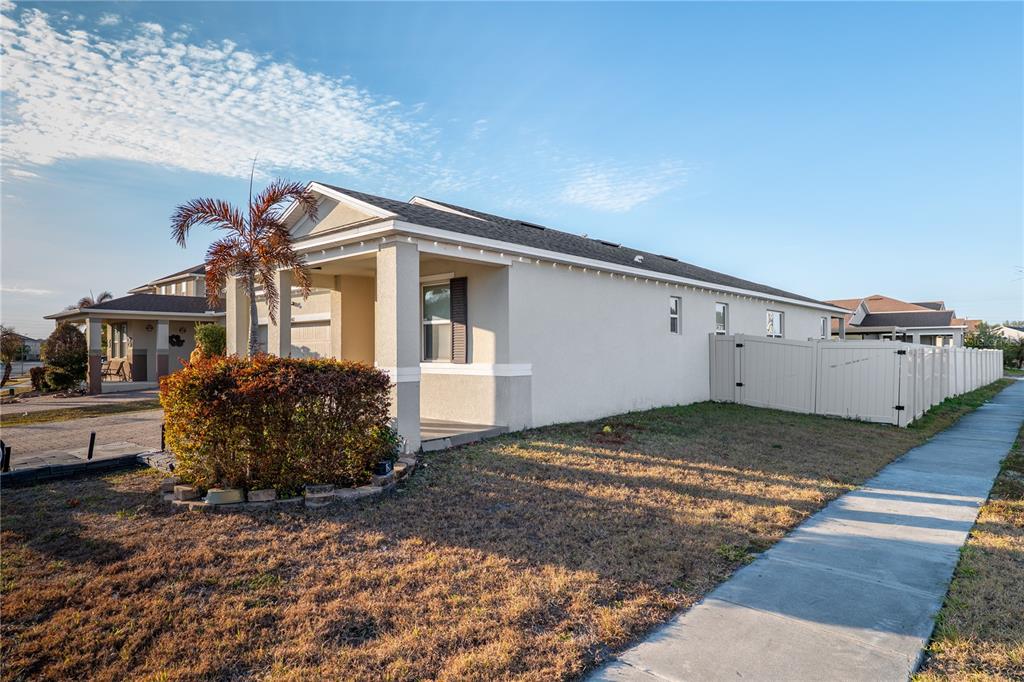 A single-story house with a beige stucco exterior, a front porch, and a vinyl fence — 3401 CANVAS STREET, KISSIMMEE, FL