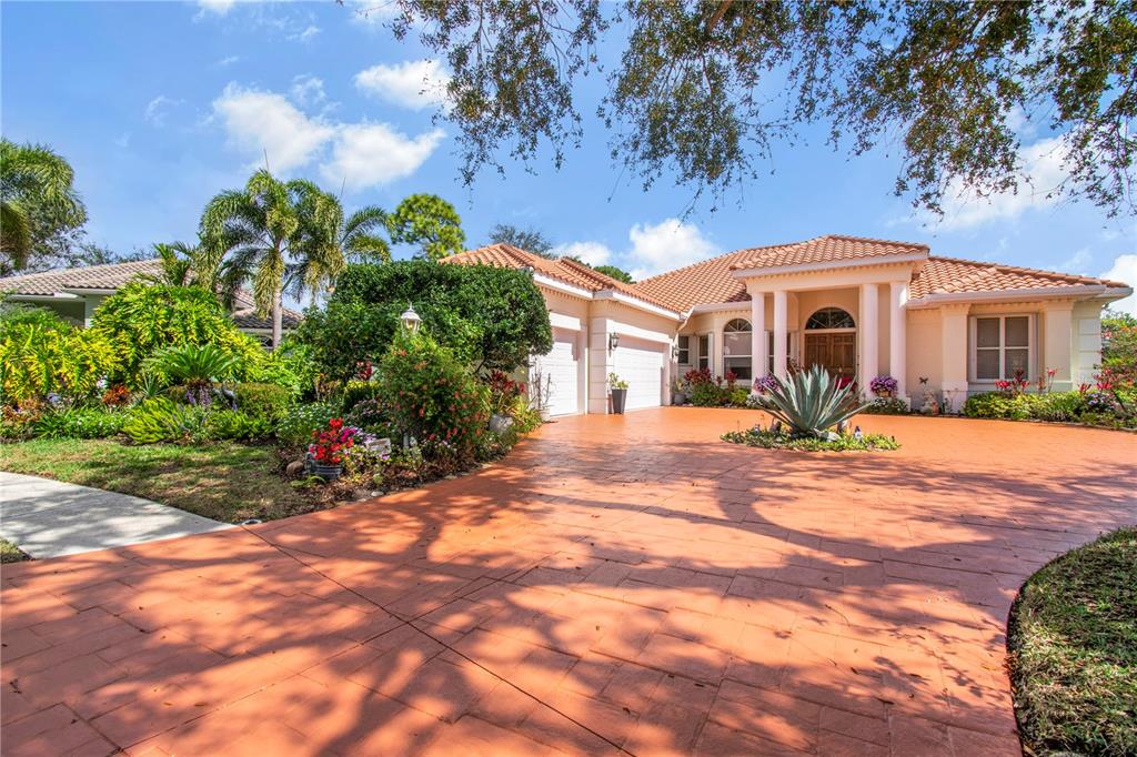 A spacious room features light tile flooring, a wooden hutch, a bar, and sliding glass doors — 7302 EATON COURT, UNIVERSITY PARK, FL