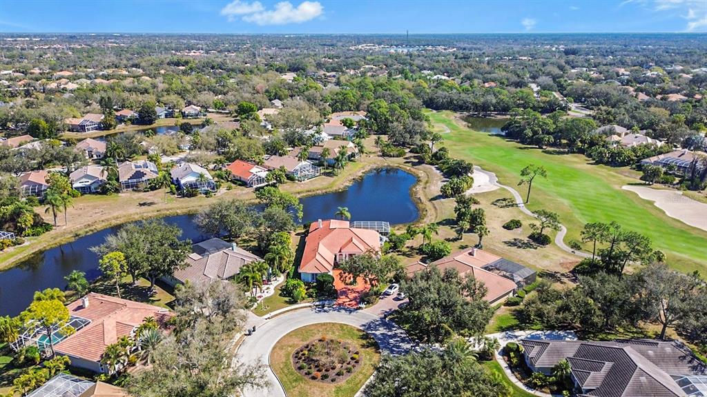 A kitchen with white cabinets, granite countertops, stainless steel appliances, and a central island — 7302 EATON COURT, UNIVERSITY PARK, FL