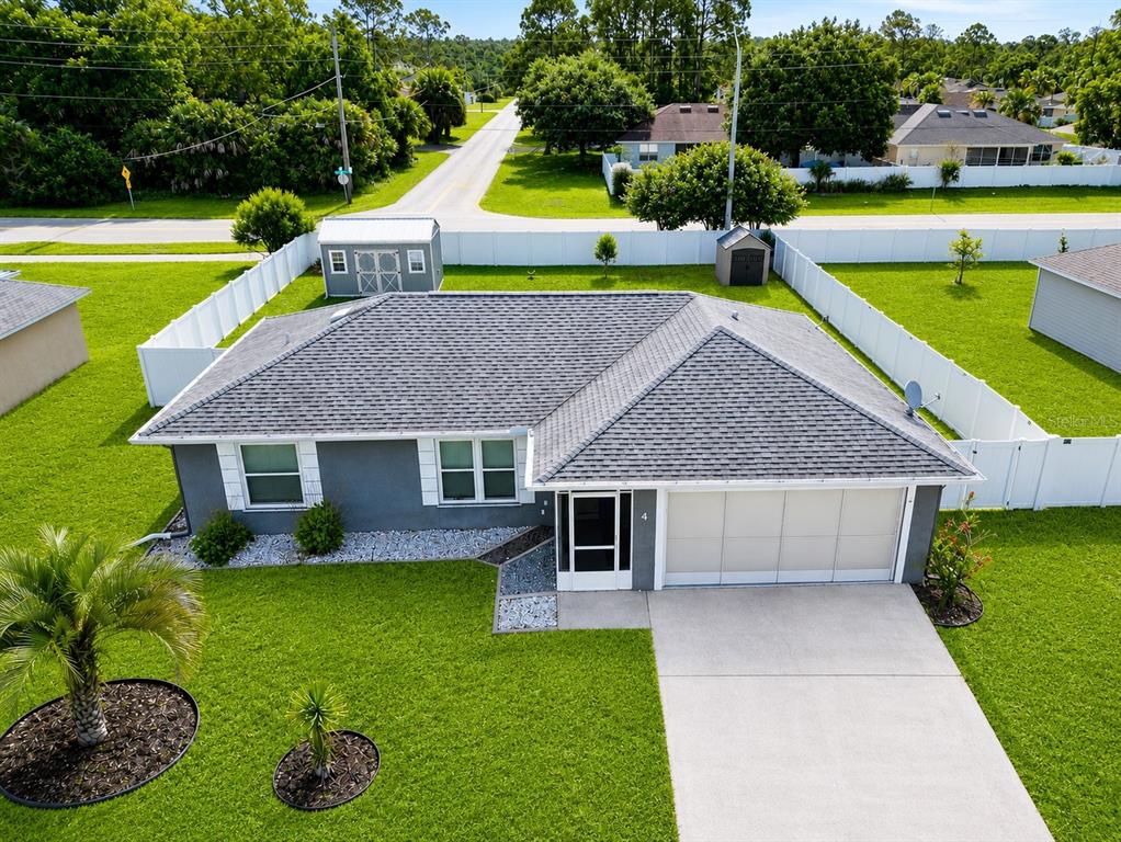 An aerial view of a single-story gray house with a shingled roof and white fence — 4 SEVERN COURT, PALM COAST, FL
