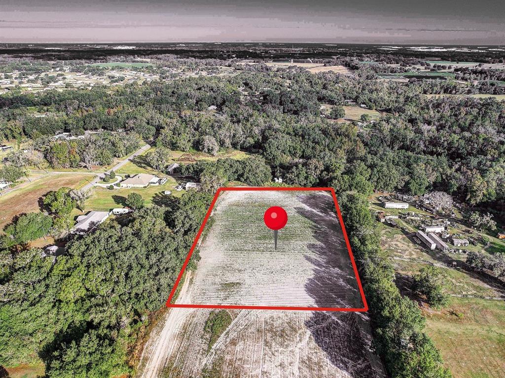 An aerial view shows a rectangular, cleared plot of land outlined in red — 4822 NESMITH ROAD, PLANT CITY, FL