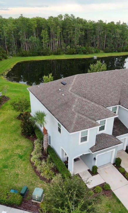 An aerial view shows a two-story house with a shingled roof next to a pond — 2163 CRYSTAL BELL STREET, ORLANDO, FL
