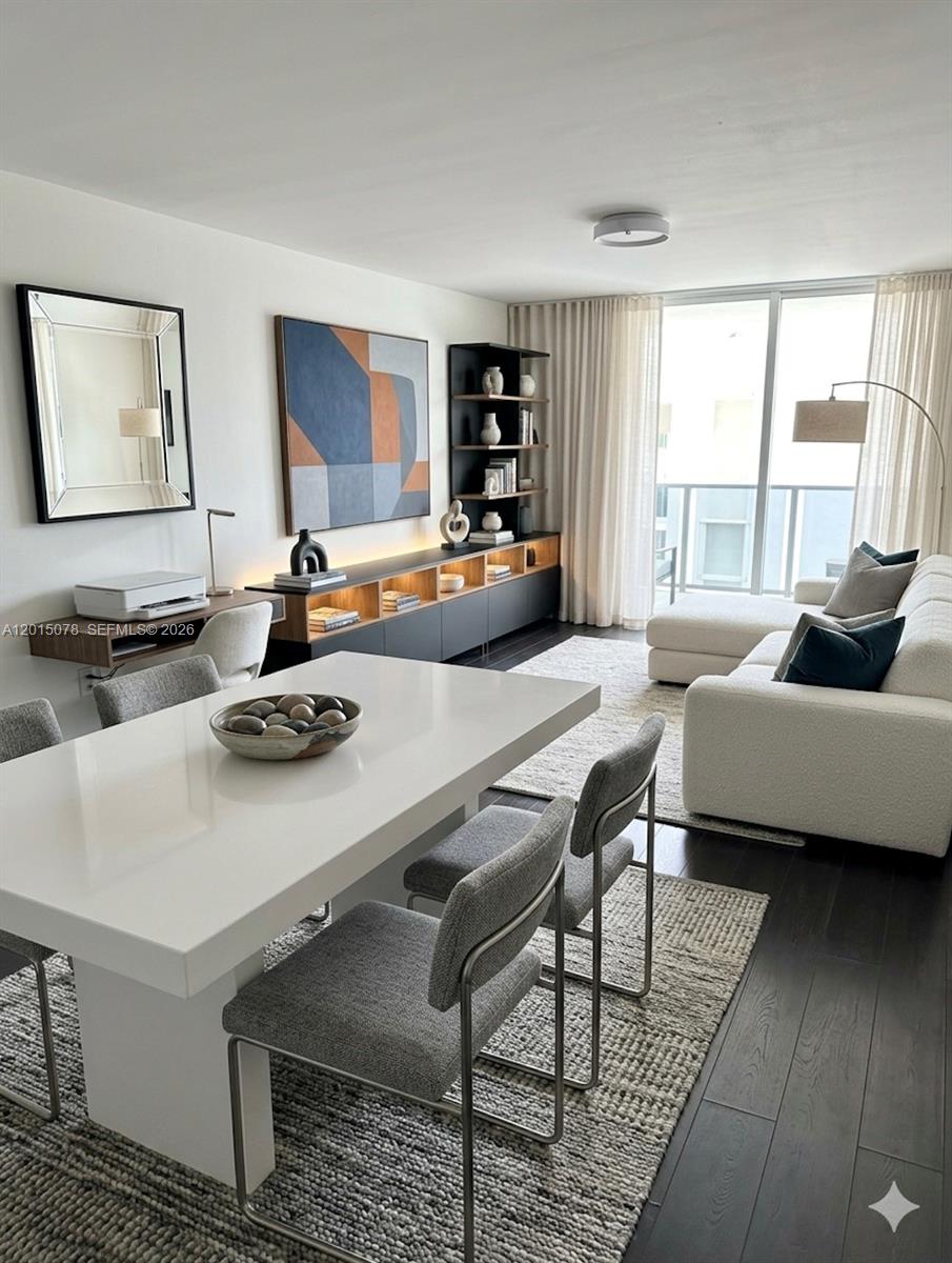 A modern living and dining area features a white table, sectional sofa, and dark flooring — 488 NW 165th St Rd # 512, Miami FL 33169, MIAMI, FL