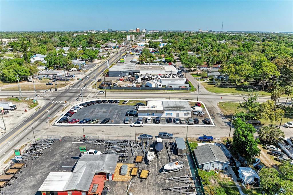 An aerial view shows a commercial property with a parking lot and adjacent boat trailers — 2929 9TH STREET W, BRADENTON, FL
