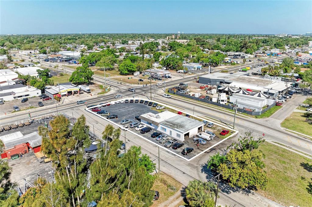 An aerial view shows a commercial building with a parking lot at a street intersection — 2929 9TH STREET W, BRADENTON, FL