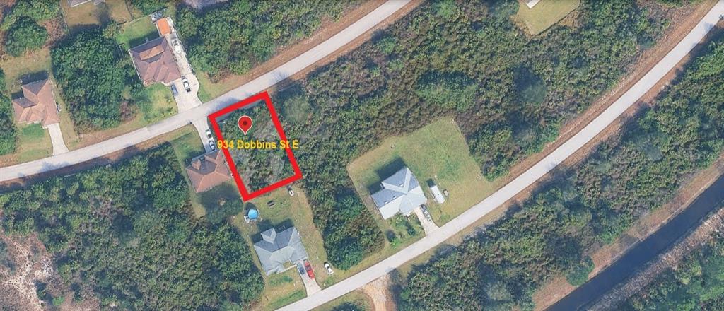 An aerial map view shows a vacant rectangular lot outlined in red — 934 DOBBINS STREET E, LEHIGH ACRES, FL