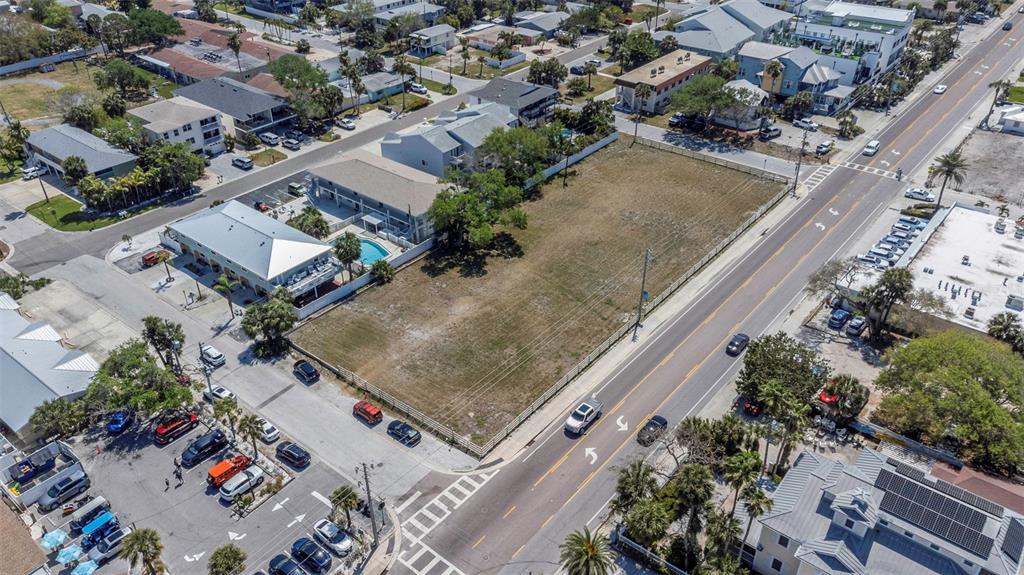 An aerial view shows a vacant rectangular lot situated between a road and residential buildings — 2300 GULF BOULEVARD, INDIAN ROCKS BEACH, FL
