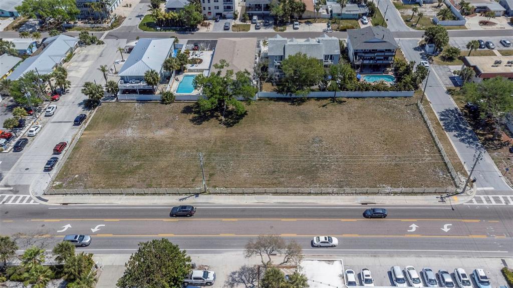 An aerial view shows a large, vacant rectangular lot bordered by roads and residential buildings — 2300 GULF BOULEVARD, INDIAN ROCKS BEACH, FL