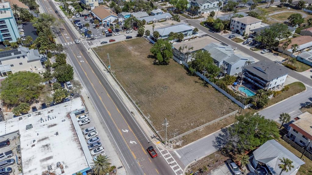 An aerial view shows a vacant rectangular lot situated between a road and residential buildings — 2300 GULF BOULEVARD, INDIAN ROCKS BEACH, FL