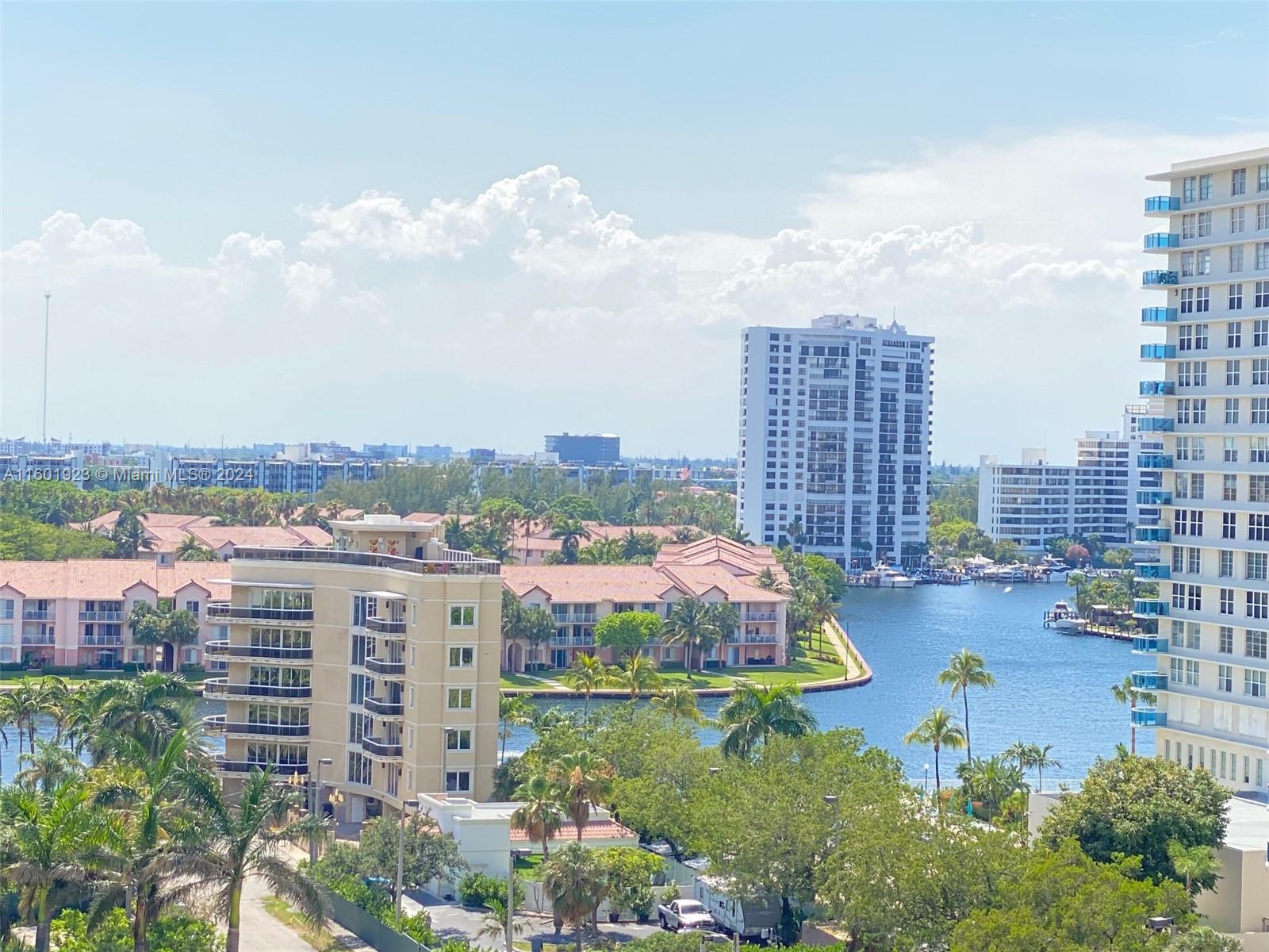An elevated view of a waterfront residential complex with mid-rise buildings and palm trees — 3901 S Ocean Dr # 10P, Hollywood FL 33019, HOLLYWOOD, FL