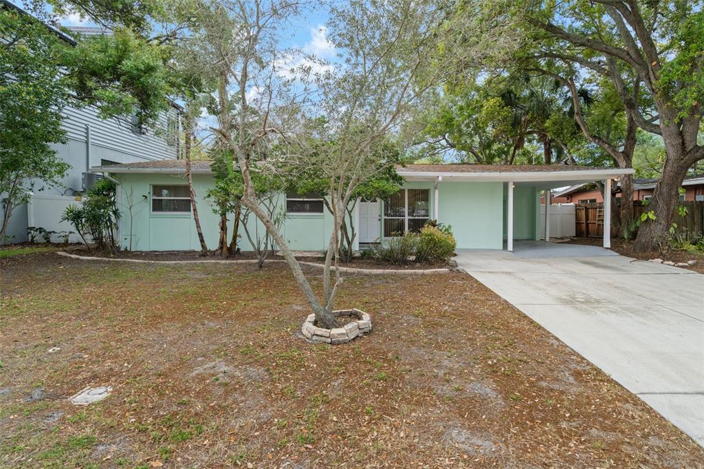 A light green single-story house with a carport and a front yard with trees — 4808 W EUCLID AVENUE, TAMPA, FL
