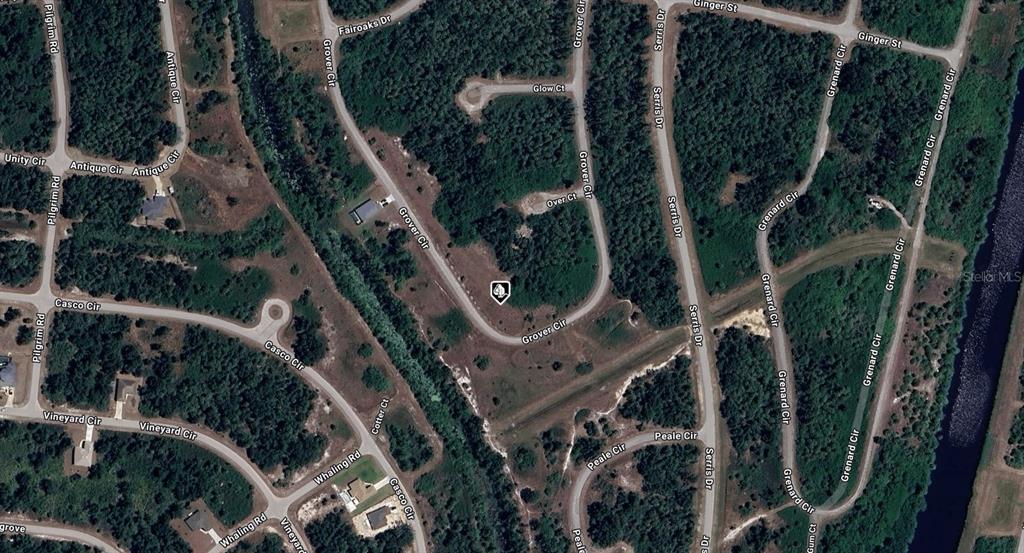 This is an aerial map view of a residential neighborhood with undeveloped lots and roads — 1149211326 GROVER CIRCLE, NORTH PORT, FL