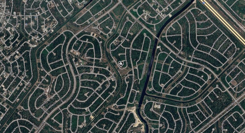 This is an aerial map view of a residential neighborhood with winding streets and trees — 1149211326 GROVER CIRCLE, NORTH PORT, FL