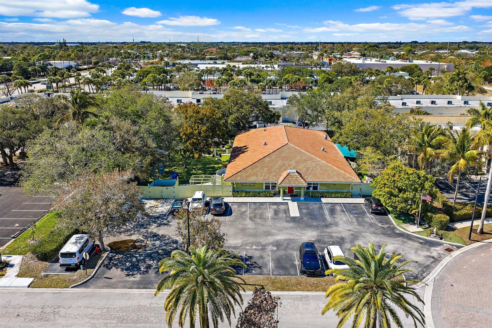 An aerial view shows a preschool building with a tiled roof and a parking lot — 100 Intracoastal Pointe Drive, Jupiter FL 33477, JUPITER, FL