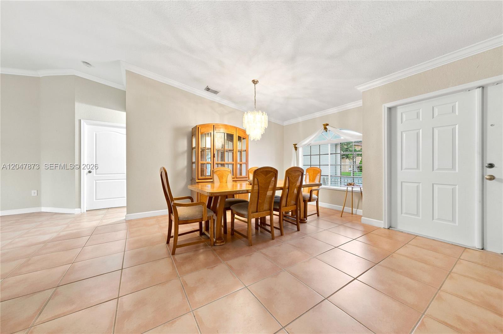 A dining room features a wooden table and chairs, a hutch, and tile flooring — 15059 SW 33rd Ter, Miami FL 33185, MIAMI, FL