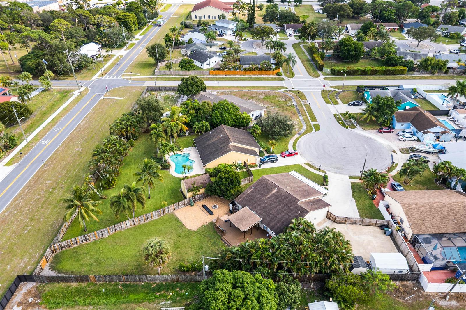 An aerial view shows two suburban houses with swimming pools and fenced yards — 6567 Cindi Lane, FL 33467, FL