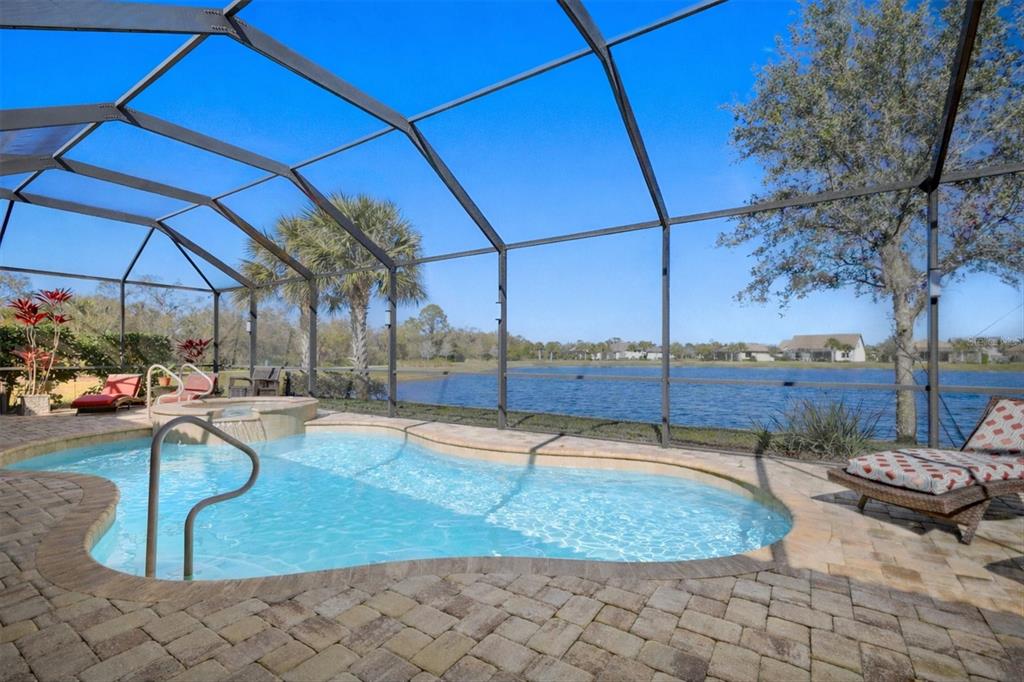 An aerial view shows a residential neighborhood with houses surrounding two ponds and trees — 17203 CORINNA PLACE, LAKEWOOD RANCH, FL