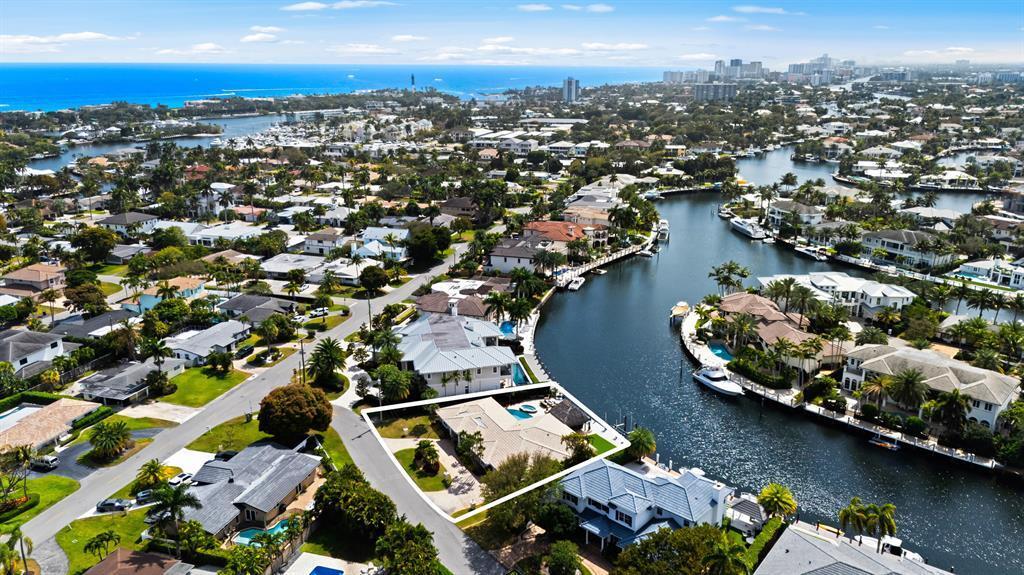 An aerial view shows a waterfront house with a pool and dock along a canal — 2600 NE 33rd Street, Lighthouse Point FL 33064, LIGHTHOUSE POINT, FL