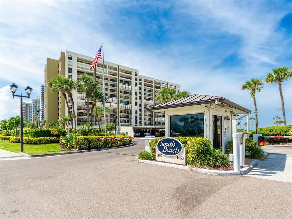 A gated entrance with a sign for South Beach leads to a multi-story apartment building — 1480 GULF BOULEVARD UNIT 610, CLEARWATER BEACH, FL