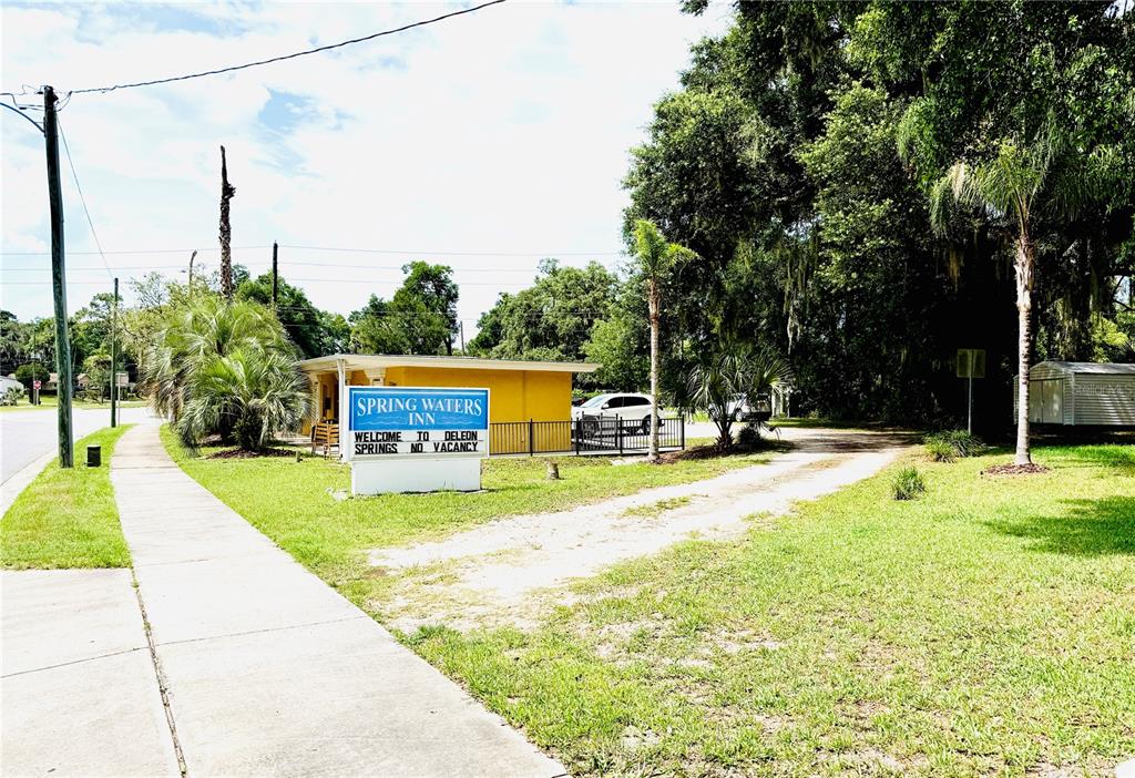 A sign for the Spring Waters Inn stands in front of a yellow building — 4851 US HIGHWAY 17 HIGHWAY, DE LEON SPRINGS, FL