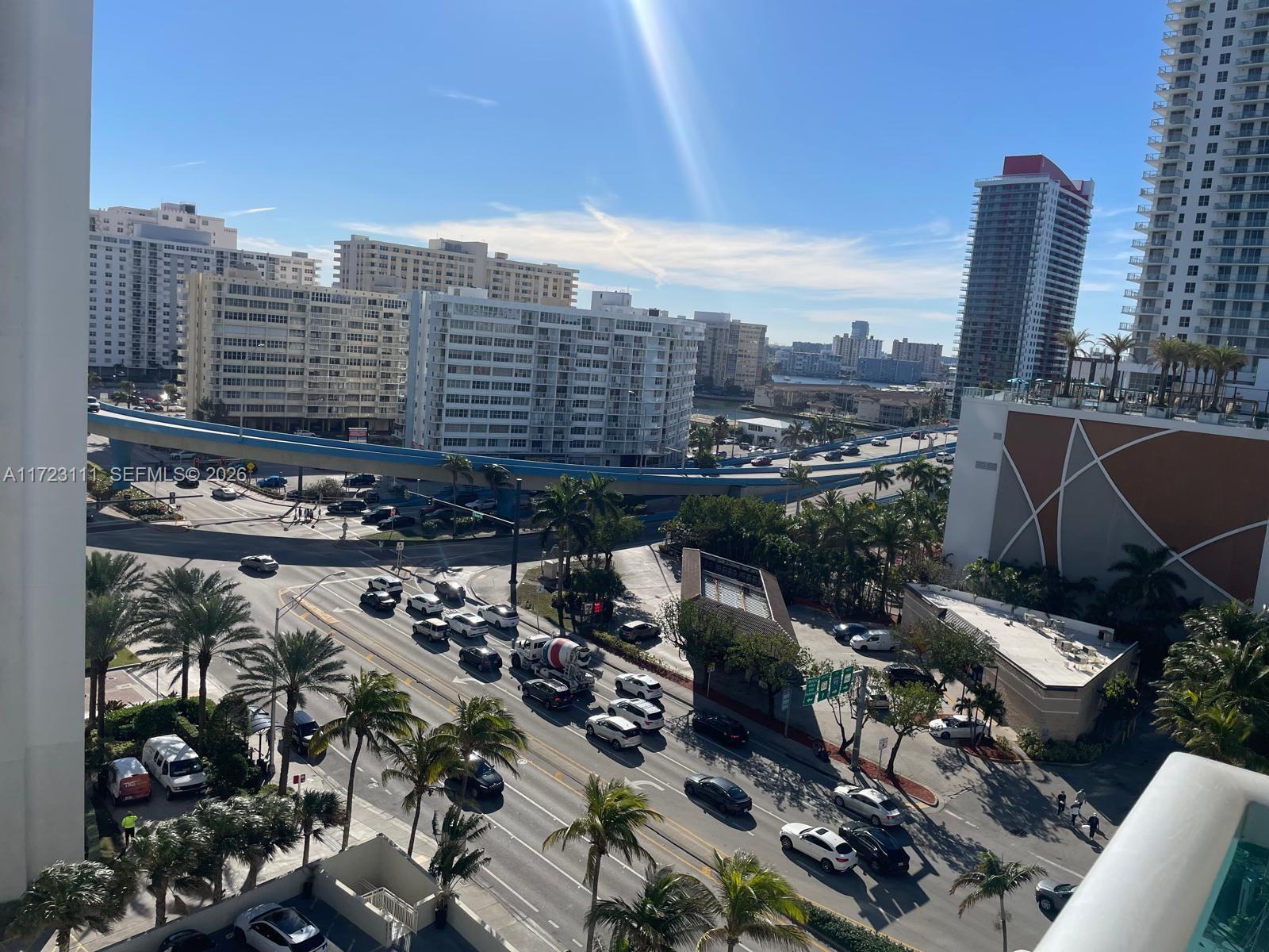 An elevated view shows a busy city intersection with palm trees and a highway overpass — 4001 S Ocean Dr # 10D, Hollywood FL 33019, HOLLYWOOD, FL