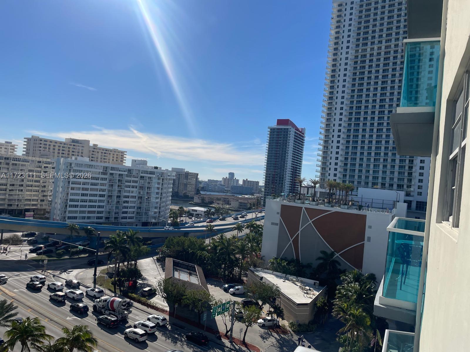 An elevated view shows a city street with traffic, palm trees, and several high-rise buildings — 4001 S Ocean Dr # 10D, Hollywood FL 33019, HOLLYWOOD, FL