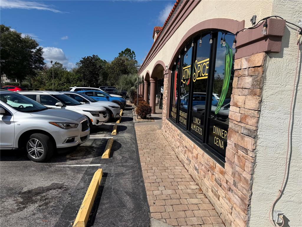 A silver SUV is parked in front of a restaurant with a stone facade — 9 NE PALM HARBOR VILLAGE WAY NE UNIT G, PALM COAST, FL