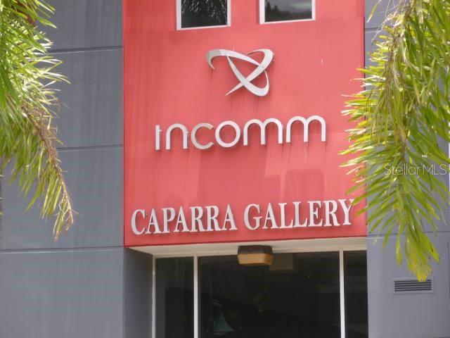 The exterior of a building features a red sign with the text Incomm Caparra Gallery — 107 GONZALEZ GUISTI AVE., GUAYNABO, PR