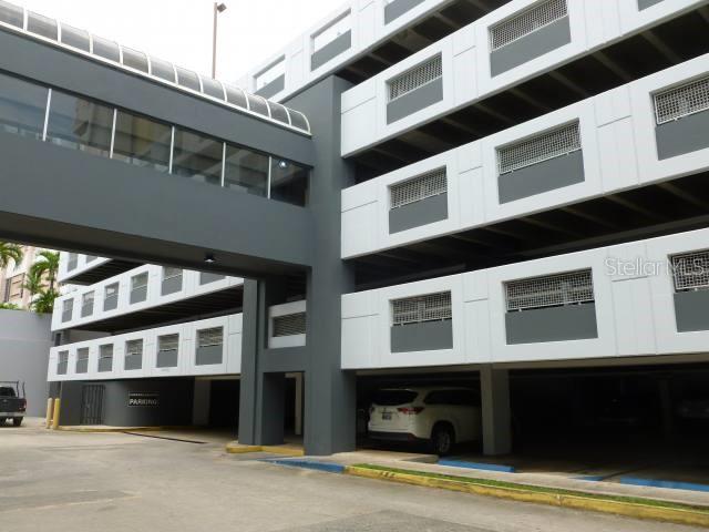 A multi-level parking garage with a covered pedestrian walkway connecting two building sections — 107 GONZALEZ GUISTI AVE., GUAYNABO, PR