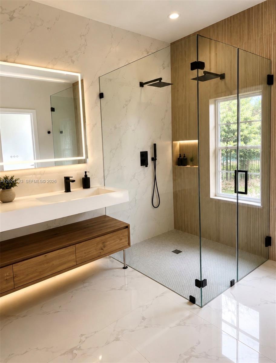 A modern bathroom features a floating wood vanity, marble-look tiles, and a glass-enclosed walk-in shower — 354 Mallard Rd # o, Weston FL 33327, WESTON, FL
