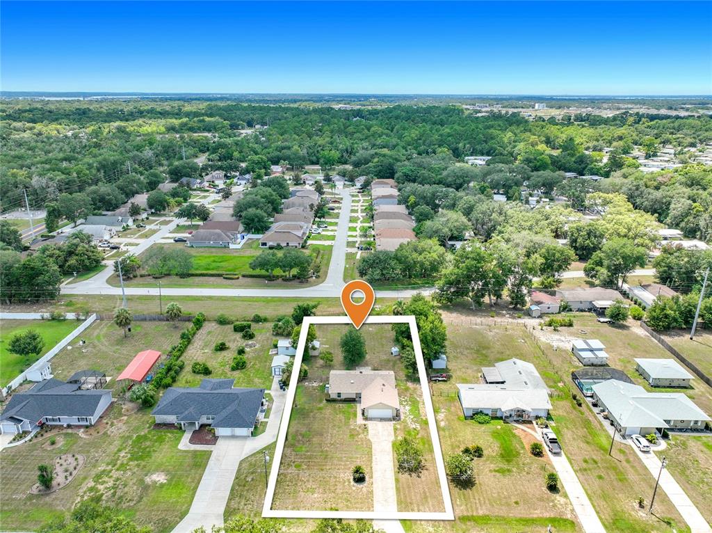 An aerial view shows a single-story house on a large, grassy lot — 2255 CROAT STREET, MOUNT DORA, FL