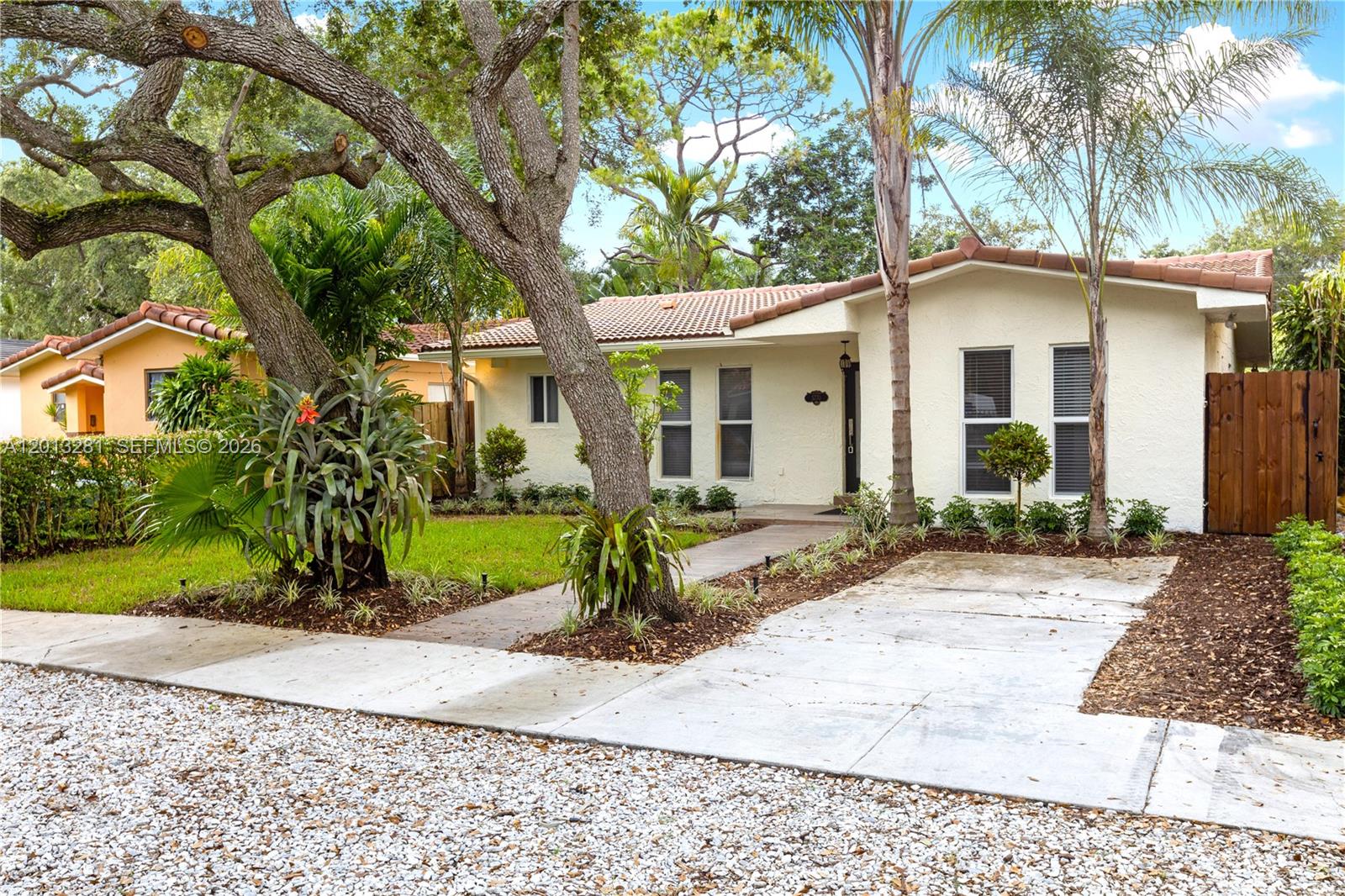 A single-story house with a white stucco exterior, tile roof, and a concrete driveway — 5770 SW 55 st, Miami FL 33155, MIAMI, FL