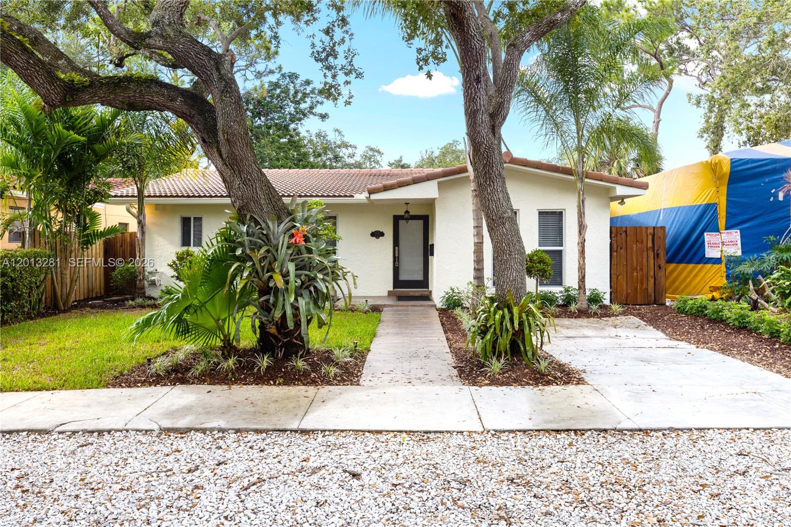 A single-story house with a white exterior, tile roof, and large trees in the yard — 5770 SW 55 st, Miami FL 33155, MIAMI, FL