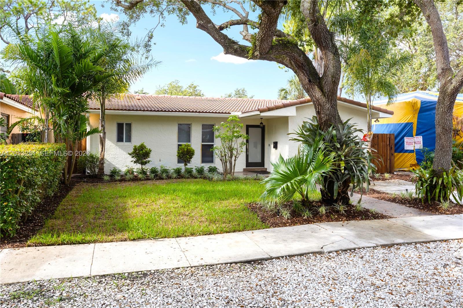 A single-story house with a white stucco facade, tiled roof, and a front lawn — 5770 SW 55 st, Miami FL 33155, MIAMI, FL