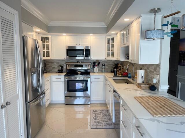 A kitchen with white cabinets, stainless steel appliances, and light-colored countertops — 500 Ocean Trail Way # 204, Jupiter FL 33477, JUPITER, FL