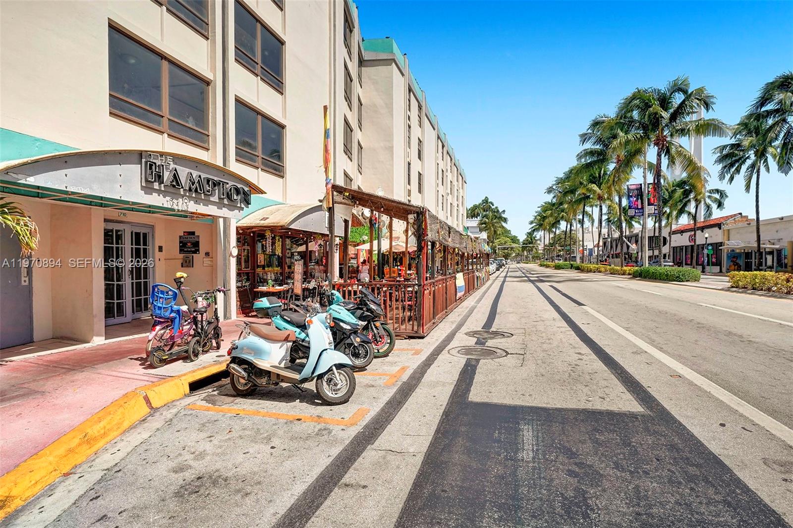 A street-level view shows a building entrance with parked scooters and an outdoor dining area — 710 Washington Ave, Miami Beach FL 33139, MIAMI BEACH, FL