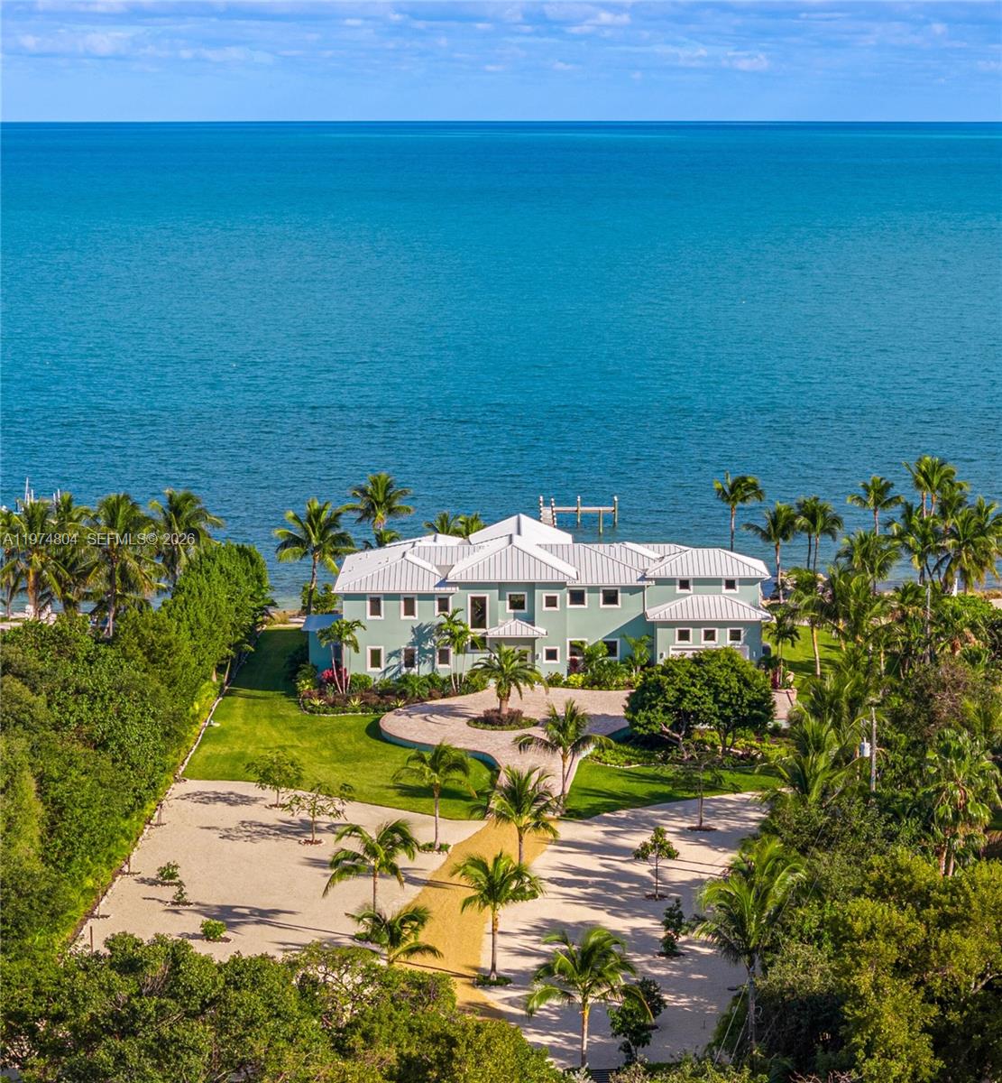 An aerial view of a large, light green waterfront house with a circular driveway — 88351 Old Hwy, Islamorada FL 33070, ISLAMORADA, FL