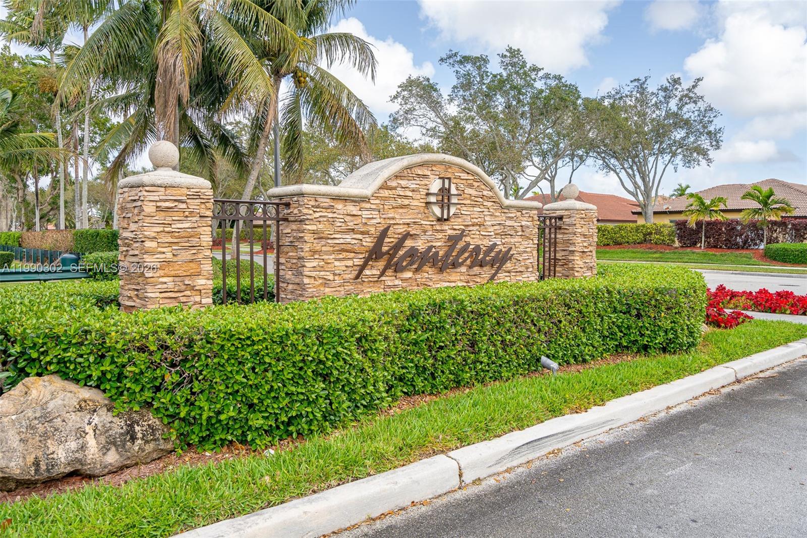 A stone entrance monument with the name Monterey stands behind a manicured hedge — 935 NE 33rd Ter # 203, Homestead FL 33033, HOMESTEAD, FL