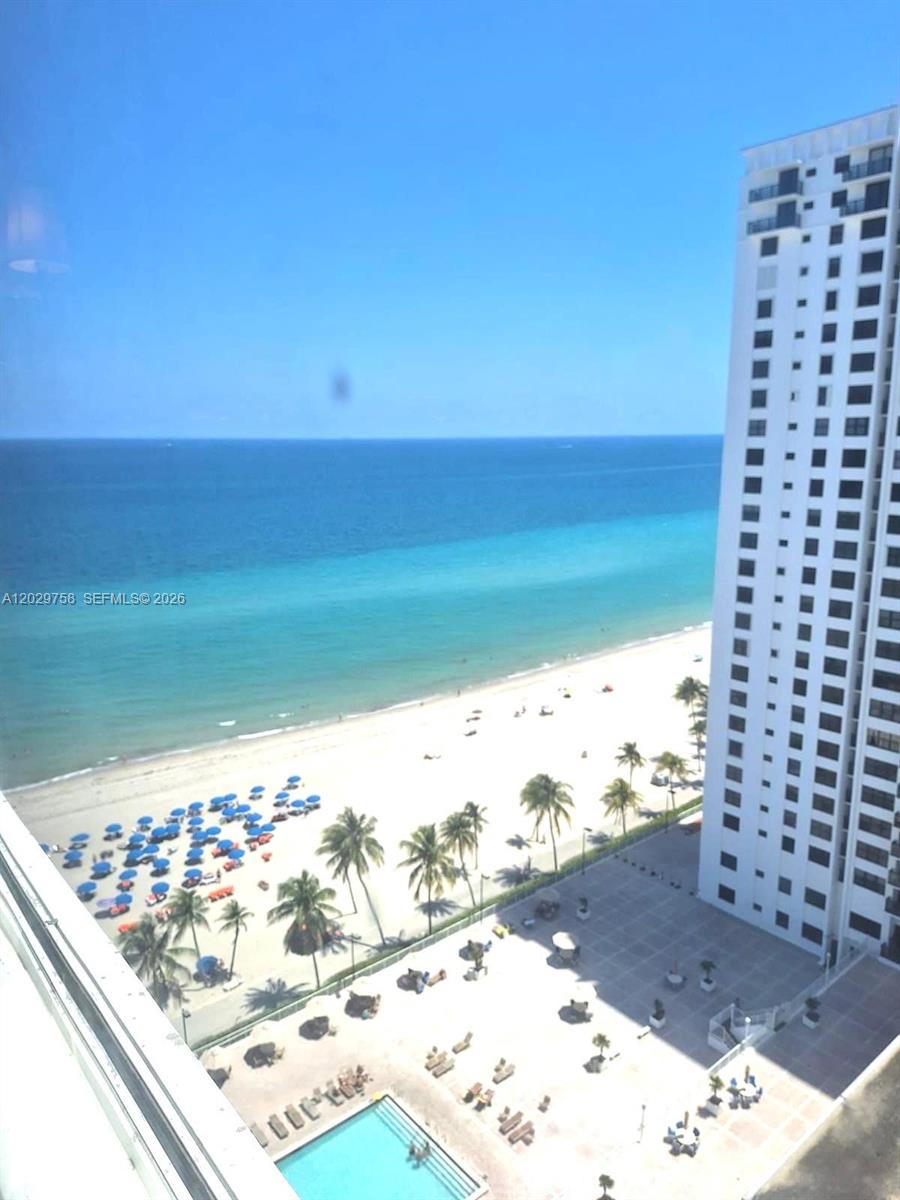 An elevated view shows a beach, ocean, swimming pool, and a tall residential building — 2201 S Ocean Dr # 2001, Hollywood FL 33019, HOLLYWOOD, FL