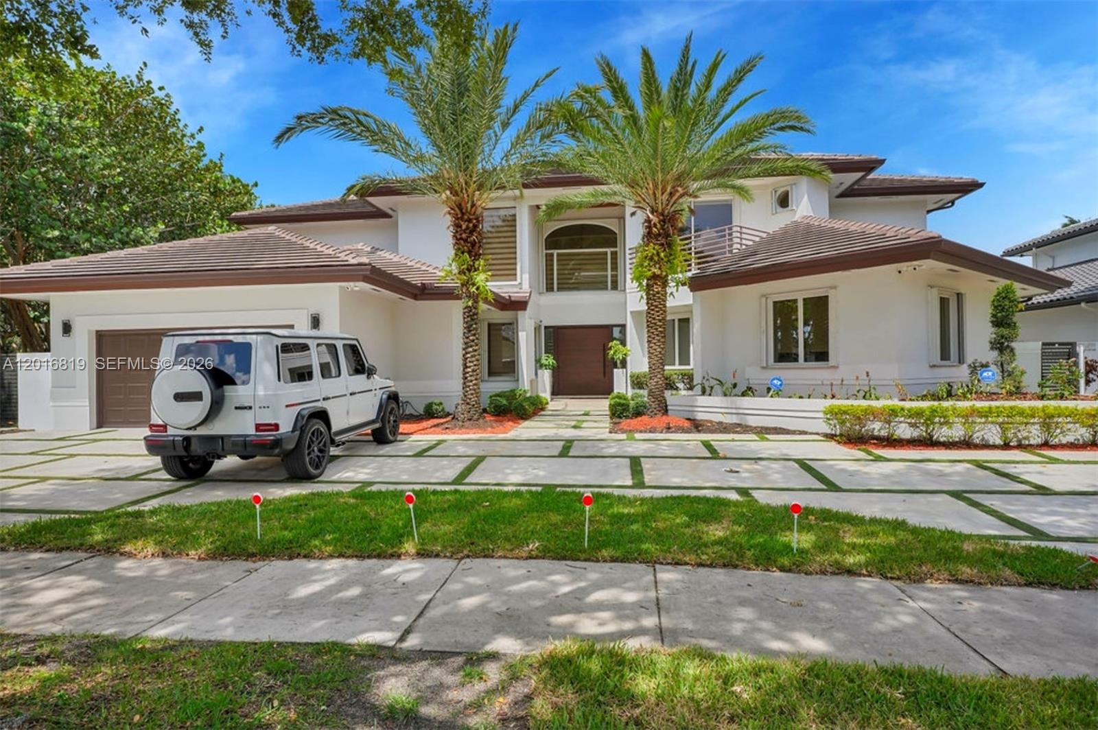 A white two-story house with a paved driveway and two palm trees in the front — 14332 Ardoch Pl, Miami Lakes FL 33016, MIAMI LAKES, FL