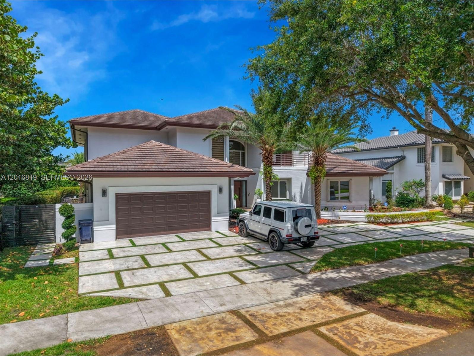 A two-story house with a brown tile roof, a white exterior, and a paved driveway — 14332 Ardoch Pl, Miami Lakes FL 33016, MIAMI LAKES, FL