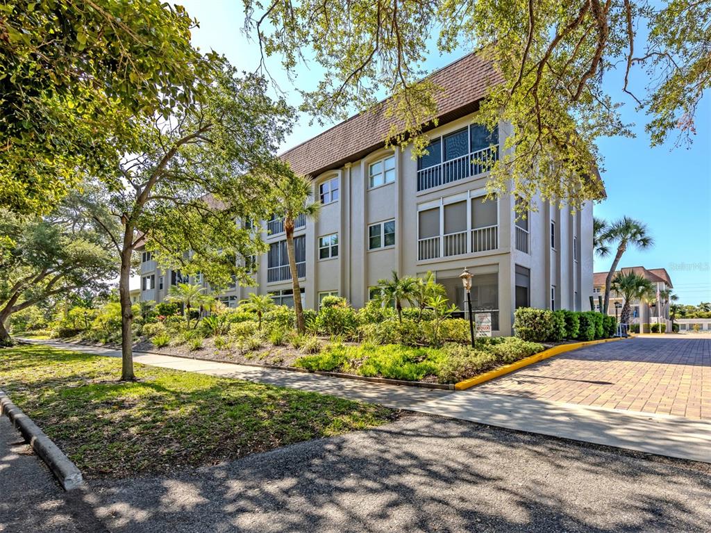 A sign reading The Venice Park is mounted under the roof eave of a building — 101 PARK BOULEVARD S UNIT 106, VENICE, FL