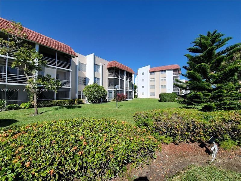 Exterior view of multi-story apartment buildings with balconies and a landscaped lawn — 3774 Inverrary Blvd # 206P, Lauderhill FL 33319, LAUDERHILL, FL