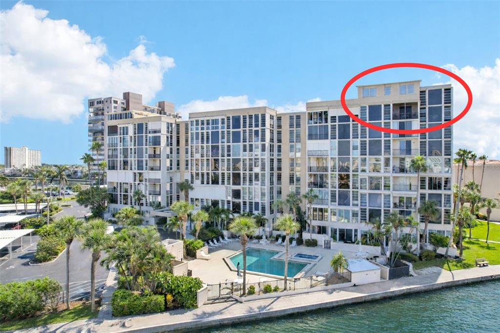 An aerial view shows a waterfront condominium complex circled in red near a bridge — 7400 SUN ISLAND DRIVE S UNIT 802, SOUTH PASADENA, FL