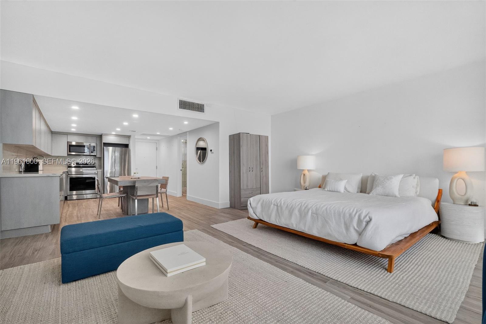 A studio apartment features a kitchen, dining area, and a bed on a light rug — 2301 Collins Ave # 943, Miami Beach FL 33139, MIAMI BEACH, FL